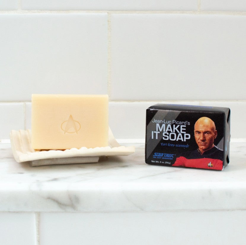 Jean-Luc Picard's Make It Soap Earl Grey Scented Bar of Soap in a Star Trek Themed wrapper and an unwrapped bar of soap on a tray.