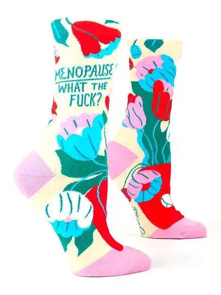 A vibrant pair of crew socks bursting with pink, blue, red, and green floral patterns, boldly asking “Menopause What The F***?” These empowering and humorous socks are the perfect funny gift for women in Canada celebrating resilience and renewal.