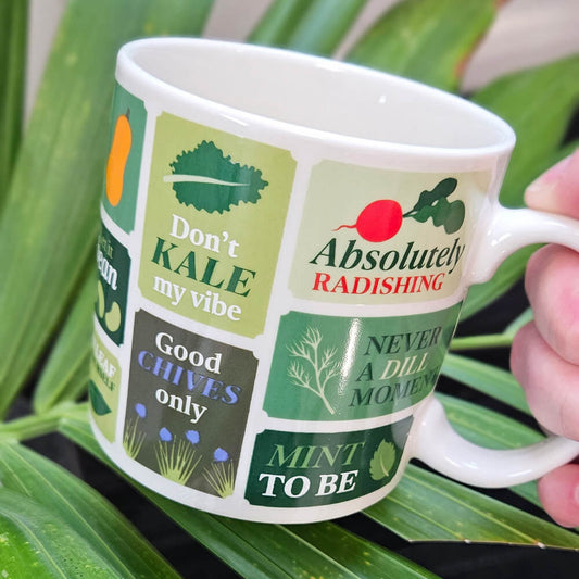 Mug with 'Freshly Picked Puns' text, held by someone in a garden setting