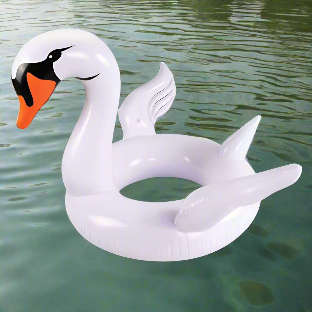 Giant white swan pool float with elegant curved neck, floating peacefully on a sparkling lake under sunny blue skies. The ultimate summer relaxation accessory from Danna Bananas.