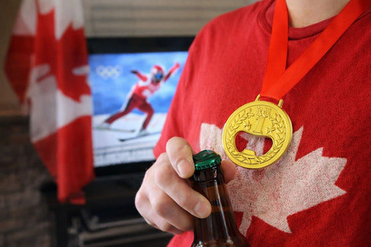 Gold medal bottle opener worn around the neck while opening a drink during an Olympic watch party in Canada