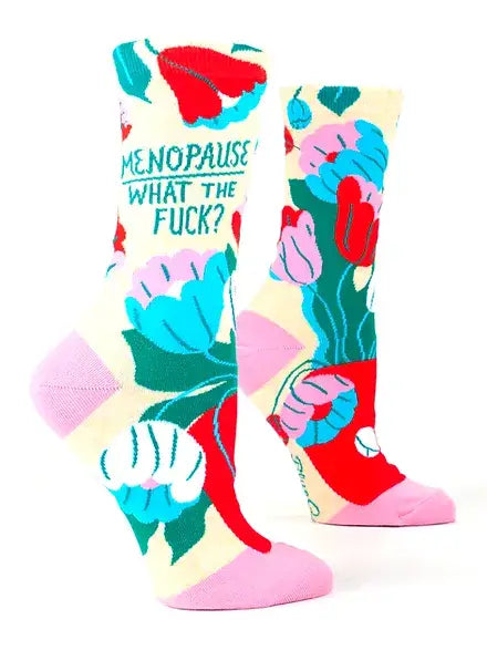 A vibrant pair of crew socks bursting with pink, blue, red, and green floral patterns, boldly asking “Menopause What The F***?” These empowering and humorous socks are the perfect funny gift for women in Canada celebrating resilience and renewal.