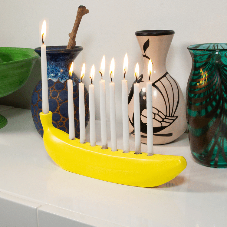 Candles burning in a Banana Menorah for Hanukah