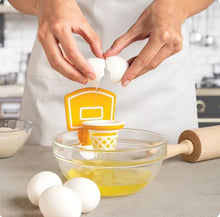 Dunk N' Egg in action—crack, separate, score. Egg whites dribbling through the net while the yolk waits for its moment of glory.