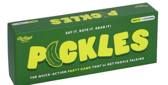 A green rectangular box of a game called "Pickles The Quick Action Party Game" by Danna Bananas. The text "Pickles" is in large yellow letters with an illustrated pickle on the letter "I." The box says, "Say it. Rate it. Grab it!" and is indicated for ages 13 and up, suitable for 3-8 players.