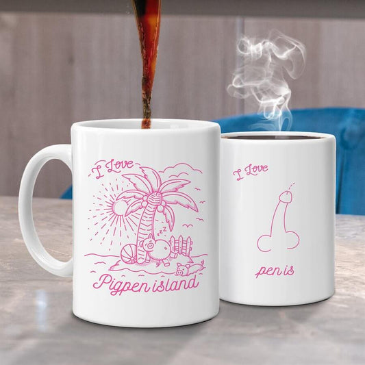 Two Jabco white mugs boast pink illustrations that transform with heat: the Pigpen Island Heat Changing Mug reveals a tropical scene with "I Love Pigpen Island" while the second reads "I Love Penis," offering a playful gift for those with a sense of humor.