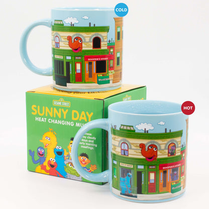 Sesame Street Sunny Days Heat Change Mug shown cold and hot with characters revealed beside the colourful gift box.