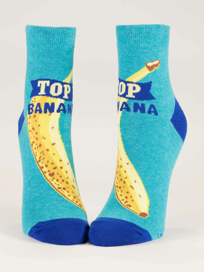 Light blue socks with bananas on them and the saying Top Banana written.