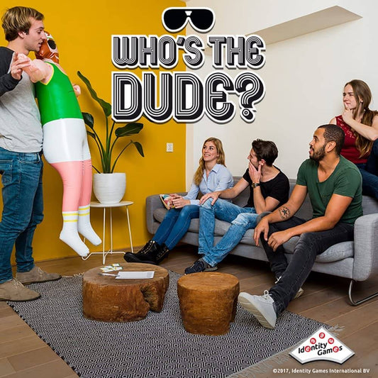 Group playing "Who's The Dude?" party charades game with life-size inflatable doll for fun and laughs.
