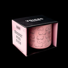 A mug in a box featuring different size and shapes of breasts.