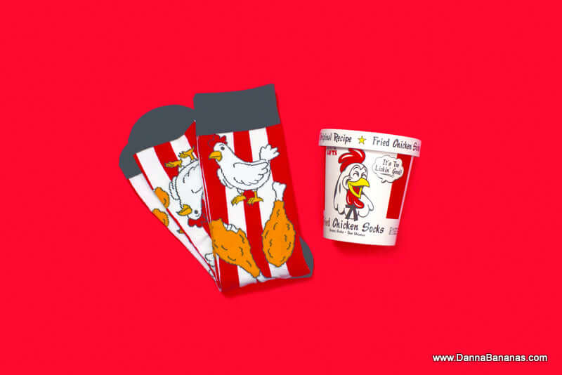 Socks with a picture of chicken and two chicken legs on them. Plus, a bucket with a picture of a chicken and the words, Fried Chicken Socks