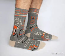 Blue Q Socks that say, “Here comes Cool Dad,” and show a super-slick man flashing a big thumbs-up as he heads out onto the scene. 