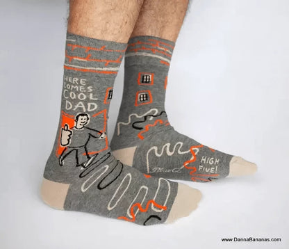 Blue Q Socks that say, “Here comes Cool Dad,” and show a super-slick man flashing a big thumbs-up as he heads out onto the scene. 