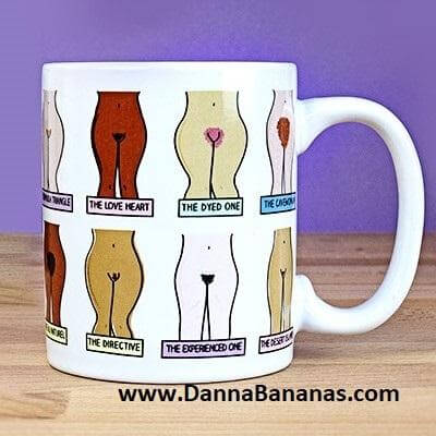 The Muff Mug by Danna Bananas is a white novelty mug with cartoon illustrations of nine distinct female pubic hair designs, each humorously labeled. The playful piece features "www.DannaBananas.com" on the bottom against a purple gradient background.