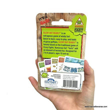A hand holds the "Silent But Deadly Card Game" by Danna Bananas, featuring a package of fart-themed cards ideal for a kid's card game night. Suitable for 2 to 6 players aged 8 and up, it includes 56 cards filled with amusing fart facts. Laughter guaranteed!